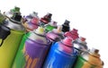 Used cans of spray paints on white background, closeup. Graffiti supplies Royalty Free Stock Photo