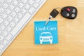 Used car message with car keys with a keyboard on a sticky note