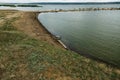 Used car tires remained in nature. The old unnecessary tire of car remained in the water. The problem of recycling waste, garbage Royalty Free Stock Photo