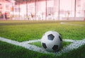 Classic black and white soccer ball on football corner marking field with no people