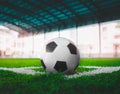 Classic black and white soccer ball on football corner marking field with no people