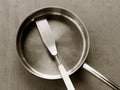 Used clean empty stainless steel frying pan and spatula overhead view on the gray background Royalty Free Stock Photo