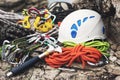 Used climbing equipment - carabiner without scratches, climbing hammer, white helmet and grey,red,green and black rope Royalty Free Stock Photo