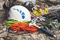 Used climbing equipment - carabiner without scratches, climbing hammer, white helmet and grey,red,green and black rope