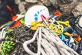 Used climbing equipment - carabiner without scratches, climbing hammer, white helmet and grey,red,green and black rope