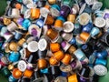 Used coffee capsules in many different colours in a disposal waste container