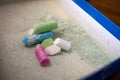 Used colored chalks with chalk powder dust in a box. Royalty Free Stock Photo