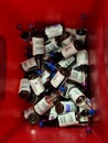 Used, contaminated blood culture bottles inside red waste container