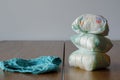 Used diapers and clean children`s pantie on a wooden table backg Royalty Free Stock Photo