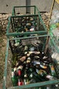 Used discarded glass bottles in trash or garbage containers. Garbage recycling concept. August 2018, Odessa, Ukraine