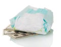 Used disposable diaper and money isolated on white.