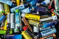 Used disposable drain batteries of various size and color on black background