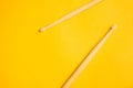 Used drumsticks isolated on yellow background. copy space Royalty Free Stock Photo
