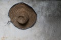 Used farmer straw hat hung on a wall