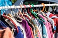 Used female sweaters on rack for reusing at flea market