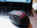 Used gaming mouse on laptop computer keyboard close up shot. Royalty Free Stock Photo