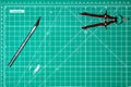 Used Green cutting mat with a compass and a razor knife with copy room Royalty Free Stock Photo