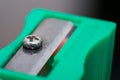 Used green pencil sharpener macro and blurred background Royalty Free Stock Photo