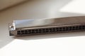 A used harmonica is located in the window frame Royalty Free Stock Photo
