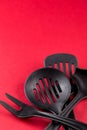 Used home kitchenware with scratches on red paper background