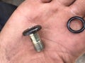 Used hydraulic bolt in dirty service man hand Royalty Free Stock Photo