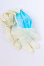Used, infected with the virus, individual white disposable gloves and a medical blue mask are thrown away unnecessary. Eco