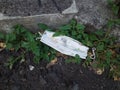 Used masks that are dumped on the side of the road Royalty Free Stock Photo