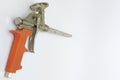 Used mounting foam gun with orange plastic handle Royalty Free Stock Photo