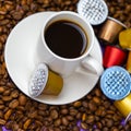 Used Nespresso capsules on coffee beans, the problem of contamination of coffee capsules. Royalty Free Stock Photo