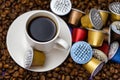 Used Nespresso capsules on coffee beans, the problem of contamination of coffee capsules. Royalty Free Stock Photo