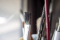 Used oil paint brushes illuminated by daylight filtering through the window. close up. Royalty Free Stock Photo