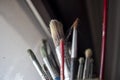 Used oil paint brushes illuminated by daylight filtering through the window. close up. Royalty Free Stock Photo