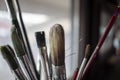Used oil paint brushes illuminated by daylight filtering through the window. close up. Royalty Free Stock Photo