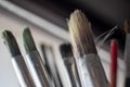 Used oil paint brushes illuminated by daylight filtering through the window. close up. Royalty Free Stock Photo