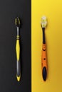 Used Old and new toothbrushes on cotrast black and yellow backgrounds. The concept of the need for frequent toothbrush changes Royalty Free Stock Photo