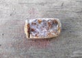 used old rusty and flattened battery on the street Royalty Free Stock Photo