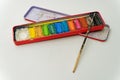 used and opened paintbox with some colorful dirty paints and bruch on white background