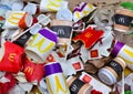 Used paper disposable packs McDonalds. Fast foodÃ¢â¬â¢s litter legacy. Discarded paper coffee cup. Pile of abandoned garbage