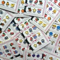 Used paper lottery cards with fruit machine symbols
