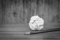 Used pencil with white crumpled paper ball put on wooden floor in black and white image. Royalty Free Stock Photo