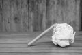 Used pencil with white crumpled paper ball put on wooden floor in black and white image. Royalty Free Stock Photo