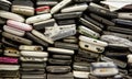 Used phones  stacked on top of each other. Background of damaged mobile phones. A bunch of old smartphones. Equipment repair and Royalty Free Stock Photo