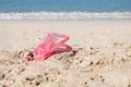 Used plastic bag on sand beach Royalty Free Stock Photo