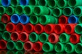 Used plastic barrels. Blue, green, and red plastic drum. Stacked of empty tank in food factory waiting for recycle and reuse. Royalty Free Stock Photo