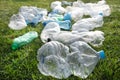 Used plastic bottles abandoned in a meadow