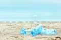 Used plastic bottles on beach, space for text. Royalty Free Stock Photo