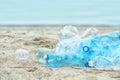 Used plastic bottles on beach, space for text. Royalty Free Stock Photo
