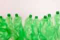 Used plastic green bottle on white background. Sorted plastic material for waste sorting and recycling