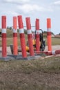 Used plastic roadwork markers at fiber connection digging site with heavy indsutrial power tools on the side Royalty Free Stock Photo