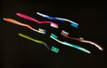 Used plastic toothbrushes on a black background. Ecology concept